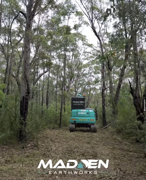 Kobelco excavator with forestry mulcher head working dense bushland