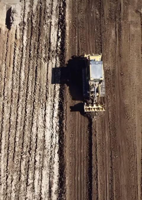 Aerial view of a CAT dozer on a freshly cleared pad in bushland, Penrith NSW
