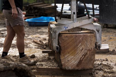 Block grab lifting a 1.4 tonne sandstone block onto the wall footing