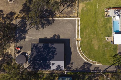 Aerial view of the finished truck-sized gravel car park around the shed, with the curved sandstone wall and lawn, Kenthurst