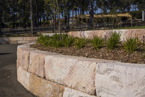Close-up of A-grade sandstone block faces and the planted garden bed on top of the wall