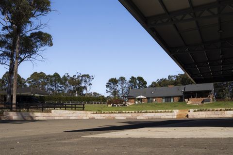 View from under the shed roof across the new gravel car park to the sandstone wall
